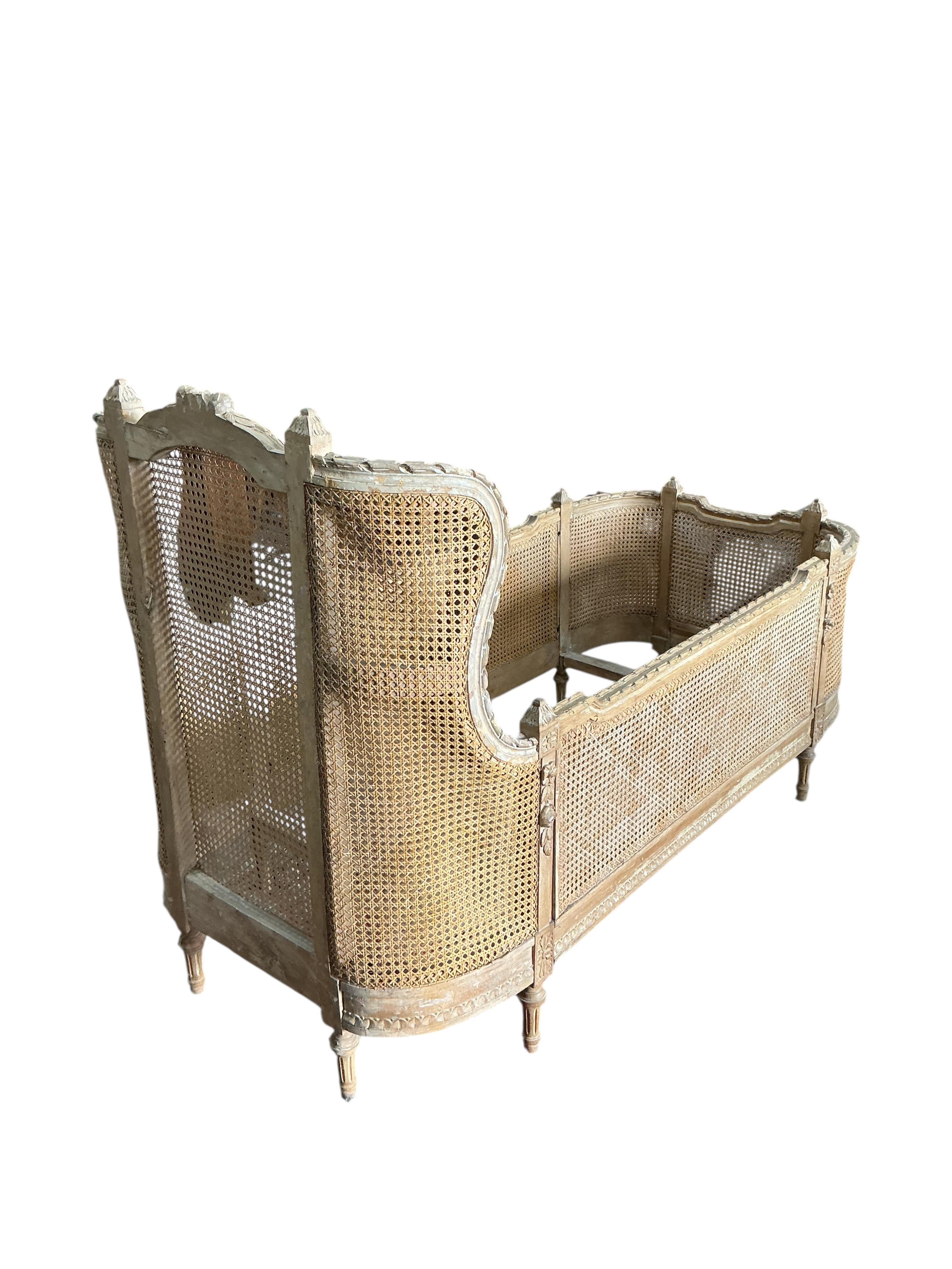 A Louis XVI style caned beech child's bed frame, width 71cm, height 105cm